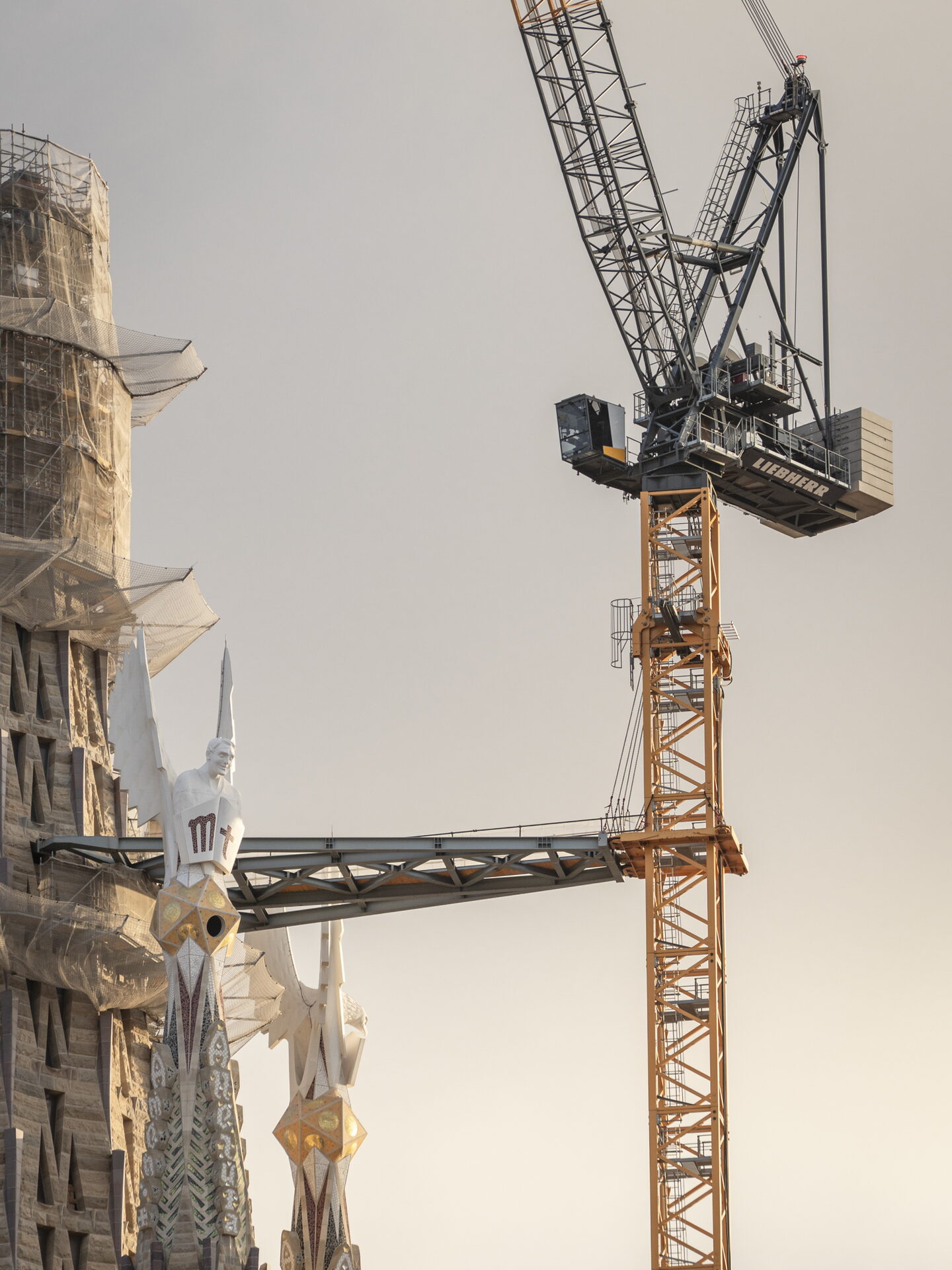 Grúa de pluma abatible Liebherr junto a las torres de la Sagrada Familia