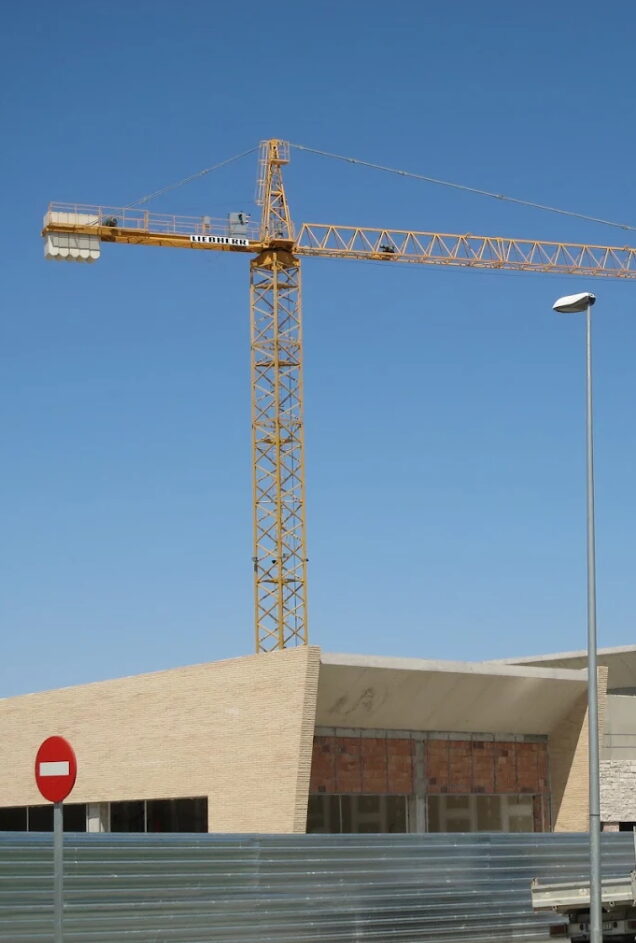 Grúa torre junto a un edificio en construcción en Huesca